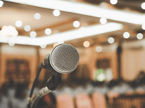 Microphone before blurred background.