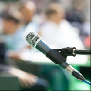 Microphone in front of blurry audience.