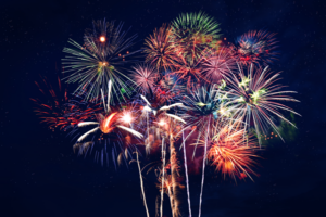 Fireworks lighting up night sky.